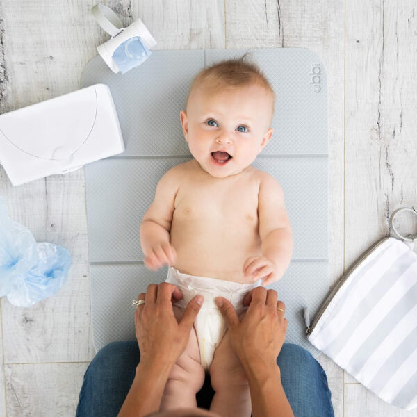 688c53bc1f29e6c064a4edaa113b1451f910a31541bb7f9c7bd43.jpg Ubbi On-The-Go Diaper Changing Baby Mat, Soft and Comfortable Diaper Bag Accessory Must Have for Newborns, Easy to Clean, Portable Folding Pad, Baby Traveling Accessories, Taupe